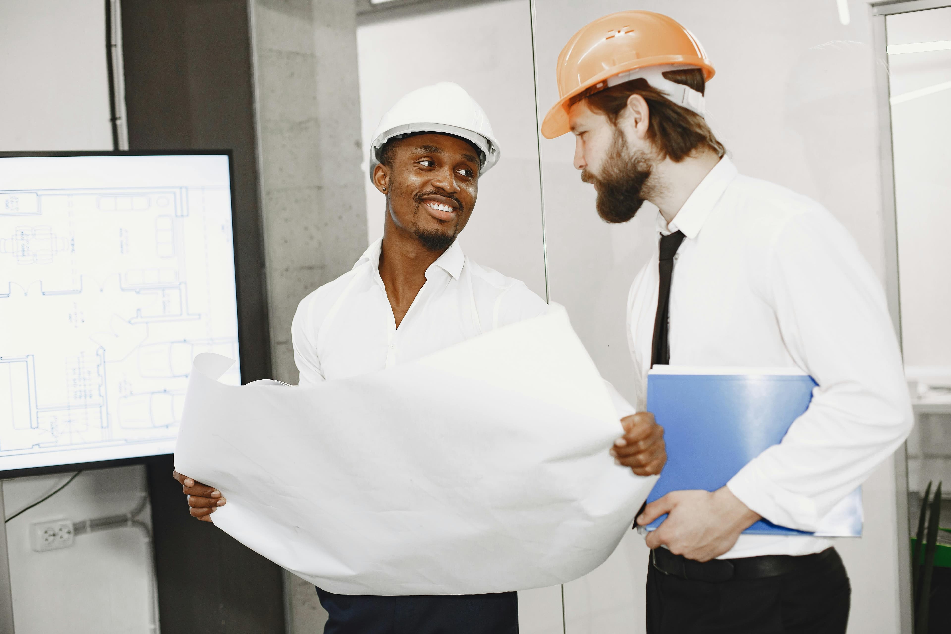 Contractors reviewing architectural plans around a table