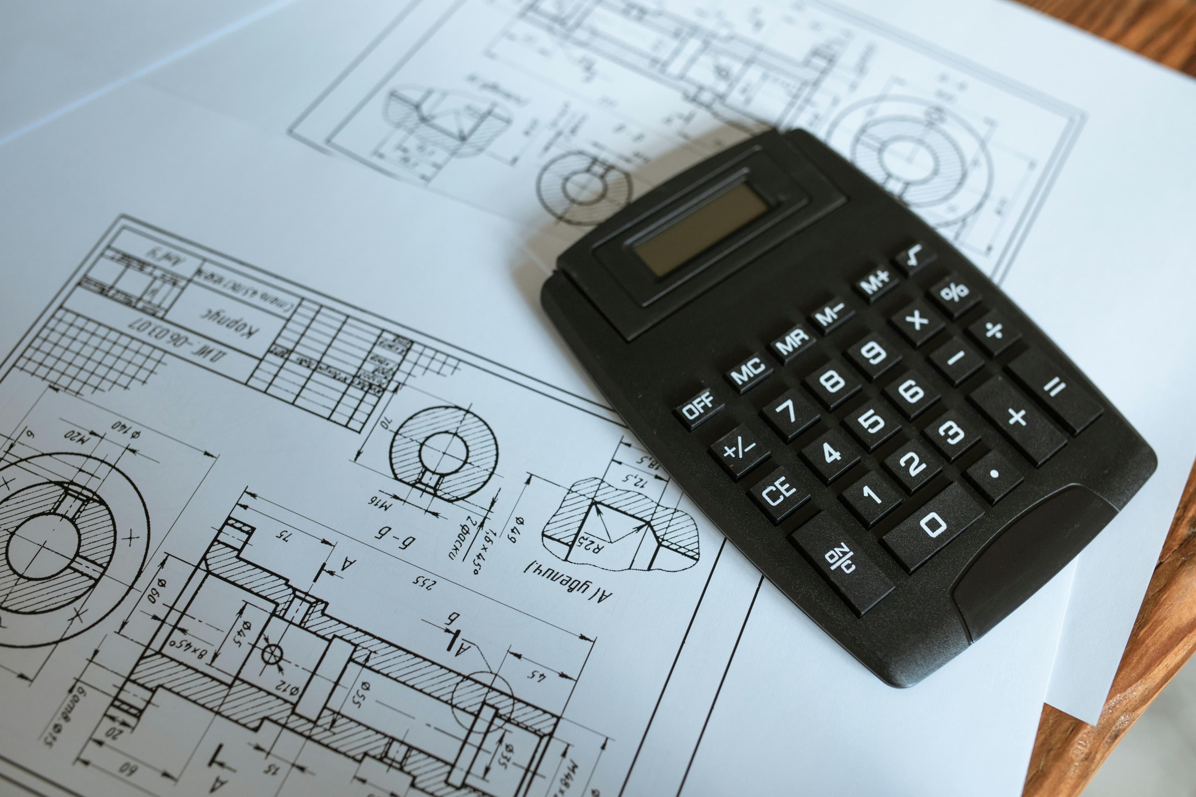 Calculator and construction drawings used for estimating ROI