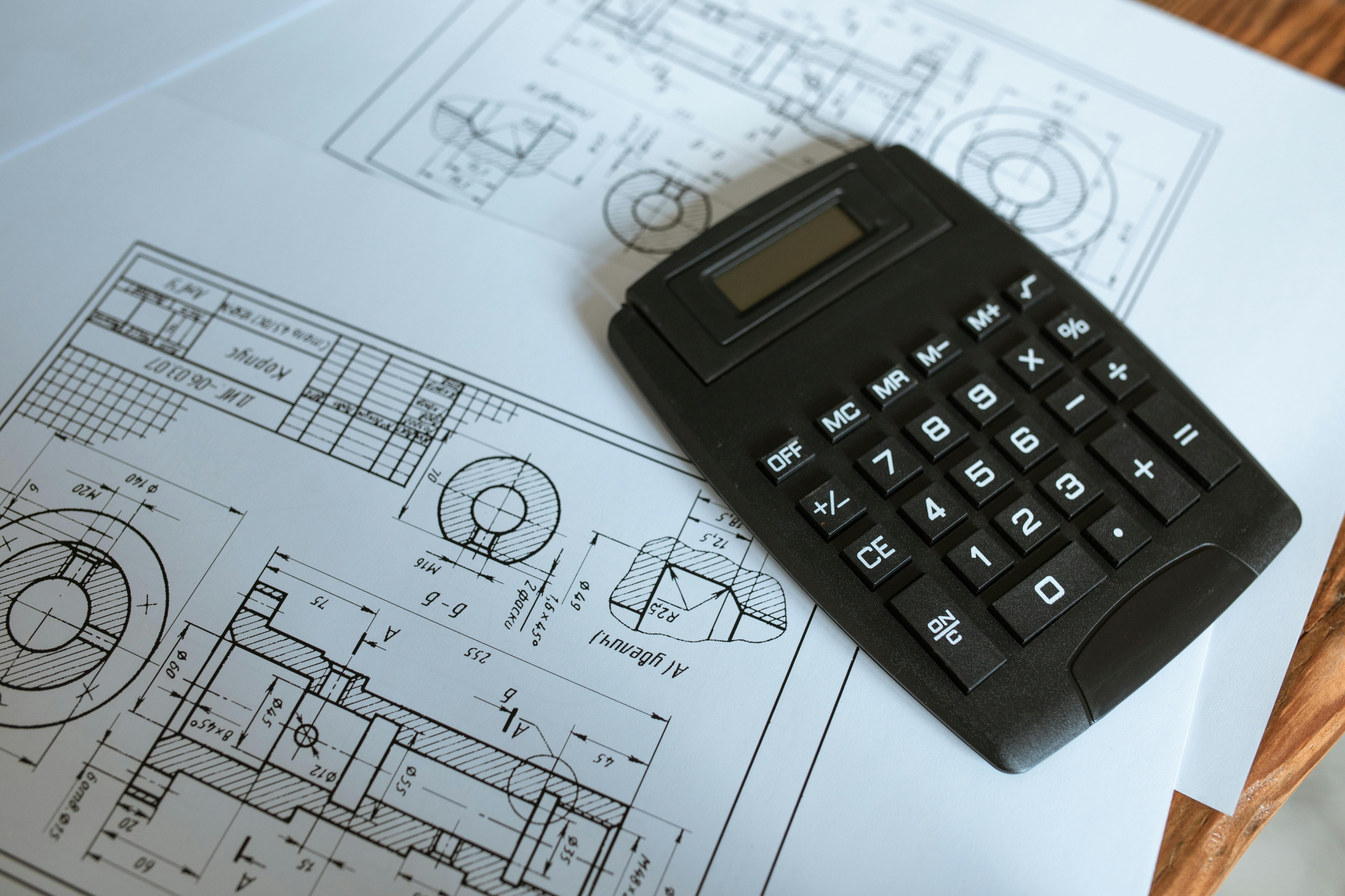 Calculator resting on construction blueprints